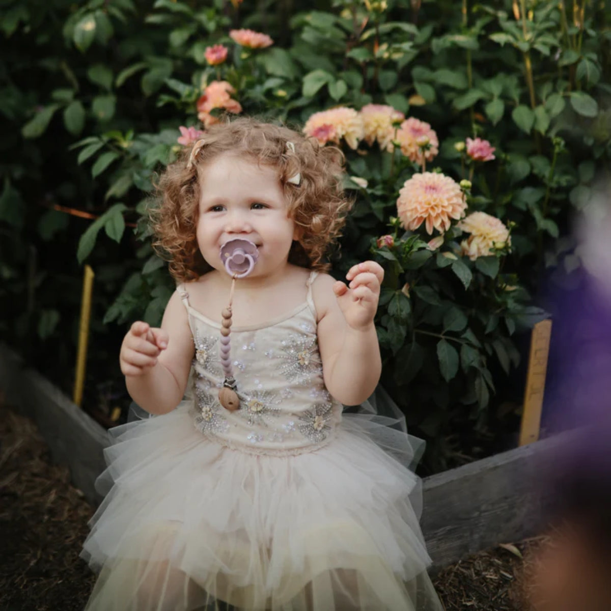 Keeps pacifiers within reach